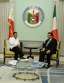 President Rodrigo Duterte (left) visits Iglesia ni Cristo leader Eduardo Manalo at the INC Central Temple in Quezon City in December 2018. Duterte Manalo meet Iglesia Ni Cristo (vert. cropped).jpg