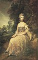 alt = امرأة جالسة في الطبيعة مع كلبها مرتديًا فستانًا مزركشًا يرجع إلى القرن الثامن عشر.