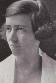 A young white woman with bobbed hair parted on the side and curled at the ends