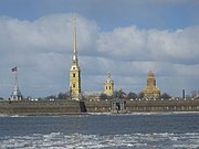  The twin golden towers of the Peter and Paul cathedral appear inside the Peter and Paul fort on the Neva river. One tower of the cathedral is being renovated (2004 April).