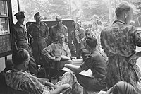 Recomba voor Noord-Sumatra dr. J.J. van der Velde in gesprek met Nederlandse officieren. Bezetting van Arnhemia, sector Padang, Sumatra, Eerste Politionele Actie, 21 juli 1947