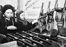 Two teen girls assemble PPD-40 submachine guns during the siege of Leningrad in 1942 Leningrad blokadnyi. Im obeim 30 let.jpg