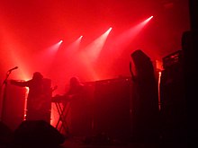 Sunn O))) onstage, bathed in red light