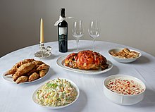 A Serbian Christmas meal with roast pork, Russian salad and red wine Christmas table (Serbian cuisine).jpg