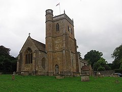 Stone building with square tower.