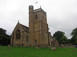 Stone building with square tower.