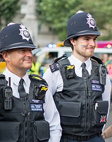 A London police officer (right) with rainbow colors on his cheek at Pride London in 2019 Pride London 39.jpg