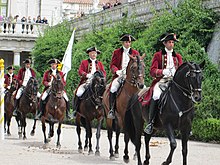 Lusitano riders of the Portuguese School of Equestrian Art, one of the "Big Four" most prestigious riding academies in the world, alongside the Cadre Noir, the Spanish Riding School, and the Royal Andalusian School. Queluz Palace horses approach (9180978620).jpg