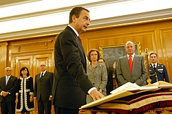 Jose Luis Rodriguez Zapatero taking the affirmation of office in his second inauguration in 2008. While placing, as mandated, the right hand in the Constitution, being a non-religious, he waived the Bible and the Crucifix. Zapatero prometiendo su cargo ante Juan Carlos I (2008).jpg