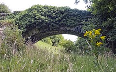 An abandoned stone bridge spans the route of the Otley and Ilkley Joint Railway through Otley, which was closed in 1965.