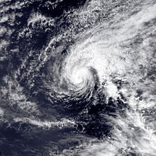 Satellite image of Hurricane Ekeka in the open sea. The tropical cyclone is somewhat elongated in appearance and has a visible albeit inconspicuous eye