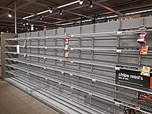 Empty shelves in a supermarket in Delft as a result of hoarding, 15 March Empty chips shelves in AH Delft 02.jpg