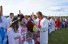 Russian Rodnover priest drawing a dot on the forehead of believers for the celebrations of Kupala Night festival. Kupala 2017 in Krasotinka, Kaluga (4).jpg