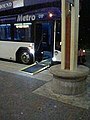 A hybrid bus with its wheel chair ramp extended
