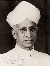 A black and white photograph of man wearing glasses and white turban