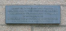 Plaque: "From the rear of this building 1,186 English born residents were deported to Germany in September 1942. In February 1943 a further 89 were deported from another location in St. Helier." Plaque deportations German occupation Jersey.jpg