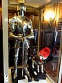 A full set of armor and a manikin of a dog in armor.