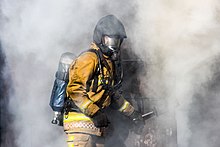 A Staffordshire Fire and Rescue Service firefighter, training in a smoke house Smoke house training.jpg