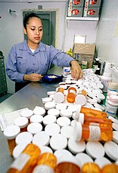 A navy corpsman in 1999 wearing the "dungaree" uniform US Navy 990523-N-8493H-001 Corpsman prepares prescriptions for USS Roosevelt crew.jpg