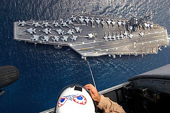 Entraînement à bord d'un hélicoptère SH-60 Seahawk. En contrebas, se trouve le porte-avions USS Dwight Eisenhower, surnommé « Ike ». Lancé le 11 octobre 1975, il est entré en service dans l’US Navy le 18 octobre 1977. (définition réelle 2 100 × 1 396)