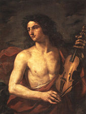  A young man with long flowing hair, bare chested, holds a stringed instrument in his left hand, while looking way to the left with a soulful expression.