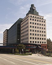 The ABC Studios building on the Walt Disney Studios Riverside Drive property in Burbank, California. The blue pedestrian overpass seen in the lower left connects it to the larger Buena Vista lot. Disney studios burbank abc building riverside.jpg