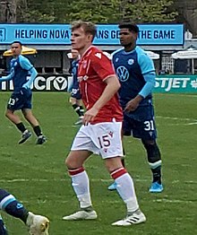 Player on the pitch looking to the left during a match