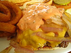 Hamburger topped with grilled onions, cheese and russian dressing.jpg