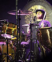 A colour photograph of Jason Bonham playing drums