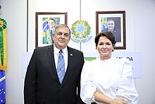 Colour photograph of Linnyer Beatrys Ruiz Aylon in 2022, wearing a suit, he is stood next an unnamed woman