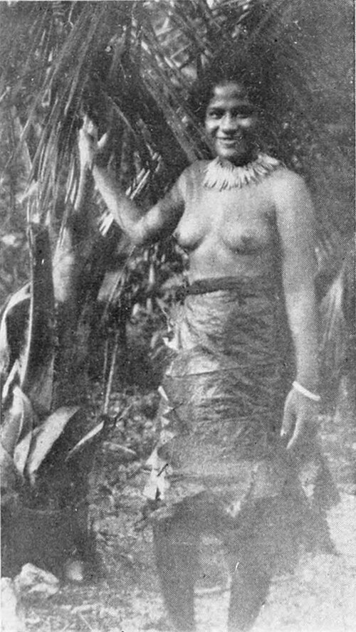 A photo of a woman posing in a bark skirt