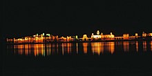 Niramhal at night, the lights of the palace are reflected in the water.