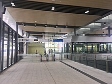 Inside station building with fare gates in front