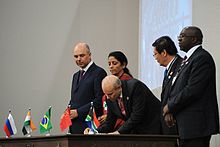 The New Development Bank (NDB) and Contingent Reserve Arrangement (CRA) were signed into treaty at the 2014 BRICS summit in Brazil. Signing of documents at 6th BRICS Summit.jpeg