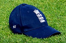 Sophie Ecclestone's traditional England cricket cap (number 157) is made of dark blue wool. There are eight panels, with the ECB ensignia at the front. Unlike the Australian style, in the English cap the wool is not baggy and the visor narrower and longer. In this image, the slight 'bagginess' is because it is not being worn 2017-18 W Ashes A v E Test 17-11-11 Ecclestone's cap (01).jpg