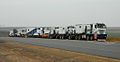 TII Nicolas Tractomas ballast tractors pulling a hydraulic modular trailer with girder bridge.