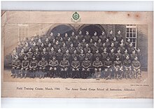 Formal picture of approx 50 males in Army Uniform, front row seated, with the Offiers, then 4 rows standing probably on benches or staging, about 15 per row, presumably of dentists who were passing out following completion of the course