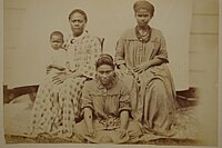 Three Marshallese women and a child in western clothes