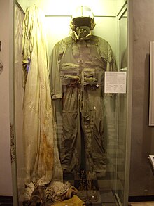 flight suit hanging in a display case