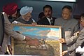 Manmohan Singh, the then prime minister of India, being presented a memento of a painting depicting Khuman Khamba capturing the "Kao" bull, by Dr. Shivinder Singh Sidhu, the then Governor of Manipur and Okram Ibobi Singh, the then Chief Minister of Manipur, on the occasion of the foundation stone laying ceremony of three projects, National Academy of Sports, Convention Center and Manipur Institute of Technology, in the Kangla in Manipur on the 2nd of December, 2006