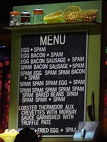 Menu from a 2014 stage performance of Monty Python's 1970 "Spam" sketch, from where the term is derived. Spam is included in almost every dish to the annoyance and dismay of a customer. Monty Python Live 02-07-14 13 04 42 (14598710791).jpg