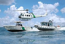 Helicopter and boats Office of CBP Air and Marine helicopter and boats.jpg
