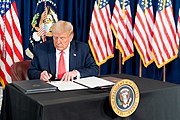 President Trump signing orders re-establishing relief pay President Trump Signs a Presidential Memorandum (50210031153).jpg