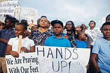 A "Hands up!" sign displayed at a Ferguson protest in August 2014 Protesters with signs in Ferguson.jpg