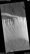 HiRISE image of the northwestern wall of Tharsis Tholus caldera. Note the outcrops of bedrock at top.