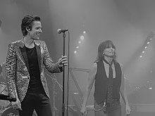 Flowers with Chrissie Hynde on The Desired Effect Tour in 2015 Brandon Flowers (with Chrissie Hynde), Brixton Academy, London (17775026150).jpg
