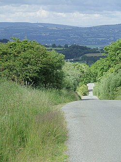 A country road in a hilly Irish landscape