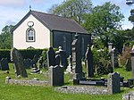 a graveyard with a chapel in the background