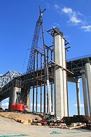Falsework placement: The section is guided to its position on foundation blocking by a ground crew.