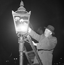 A lamplighter igniting a gas streetlight in Sweden, 1953. Stockholmgas 1953.jpg